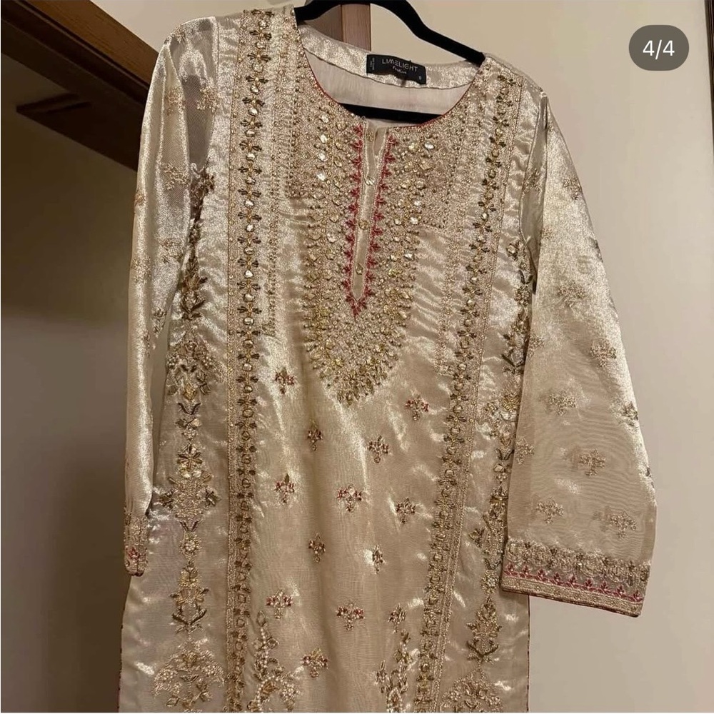 Embellished Ivory and Gold Shalwar Kameez. From Limelight in Pakistan.